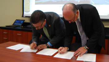 Signing documents at Wichita state university