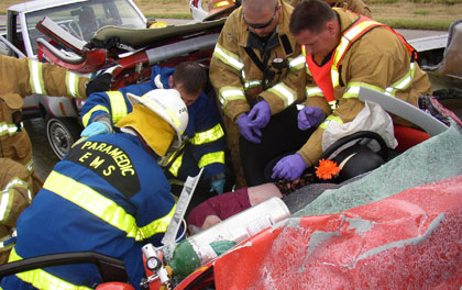 Sedgwick County EMS Paramedic assist in the extrication of a patient from a motor vehicle accident.