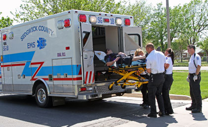 Sedgwick County EMS Paramedics load patient into back of ambulance.