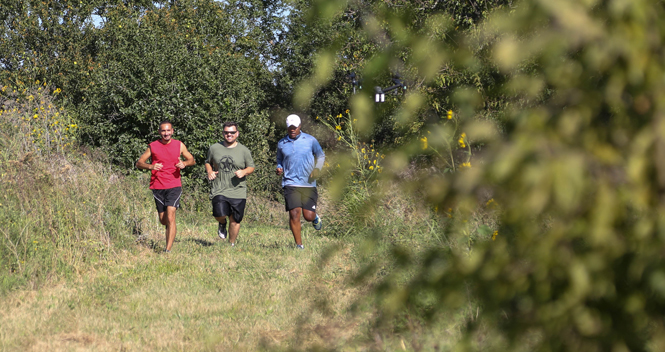 3 men Trail running at Northeast Sedgwick county park