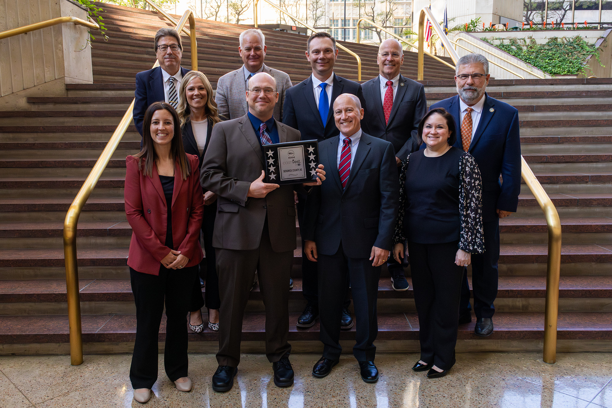 Members of the Sedgwick County Department of Finance celebrate their cashVest 90+ award with Sedgwick County Commissioners.