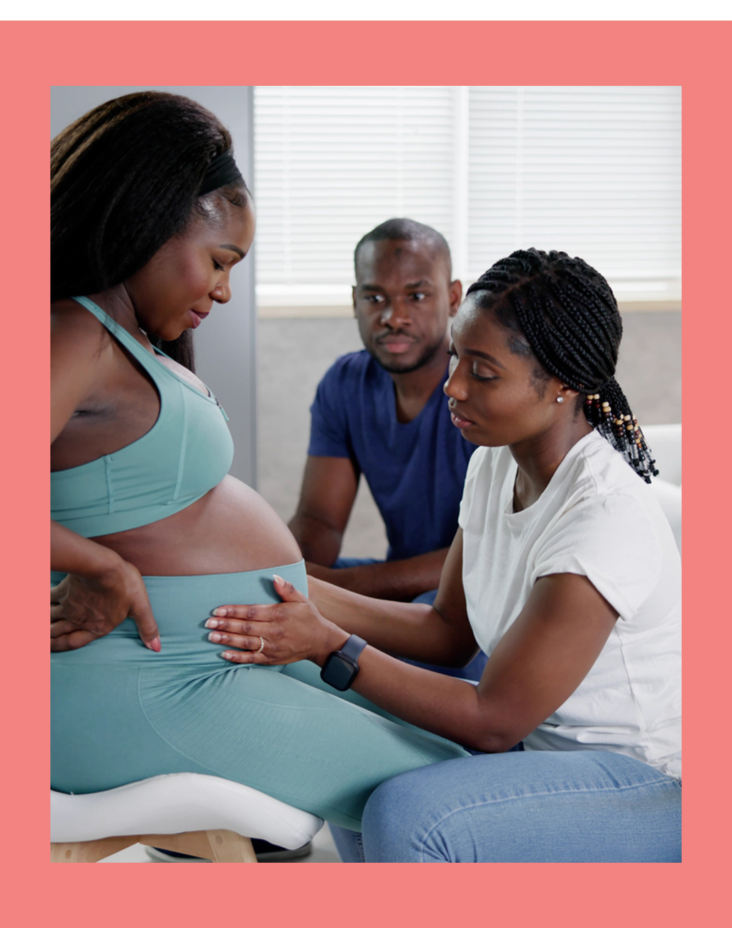 Pregnant Women sitting down with two support people