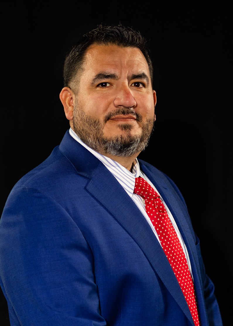 photo of Mario Salinas in blue suit and red tie